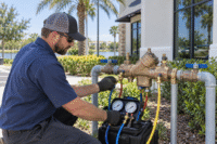 Backflow Testing in Winter Garden for a commercial plumbing assembly outside a local property